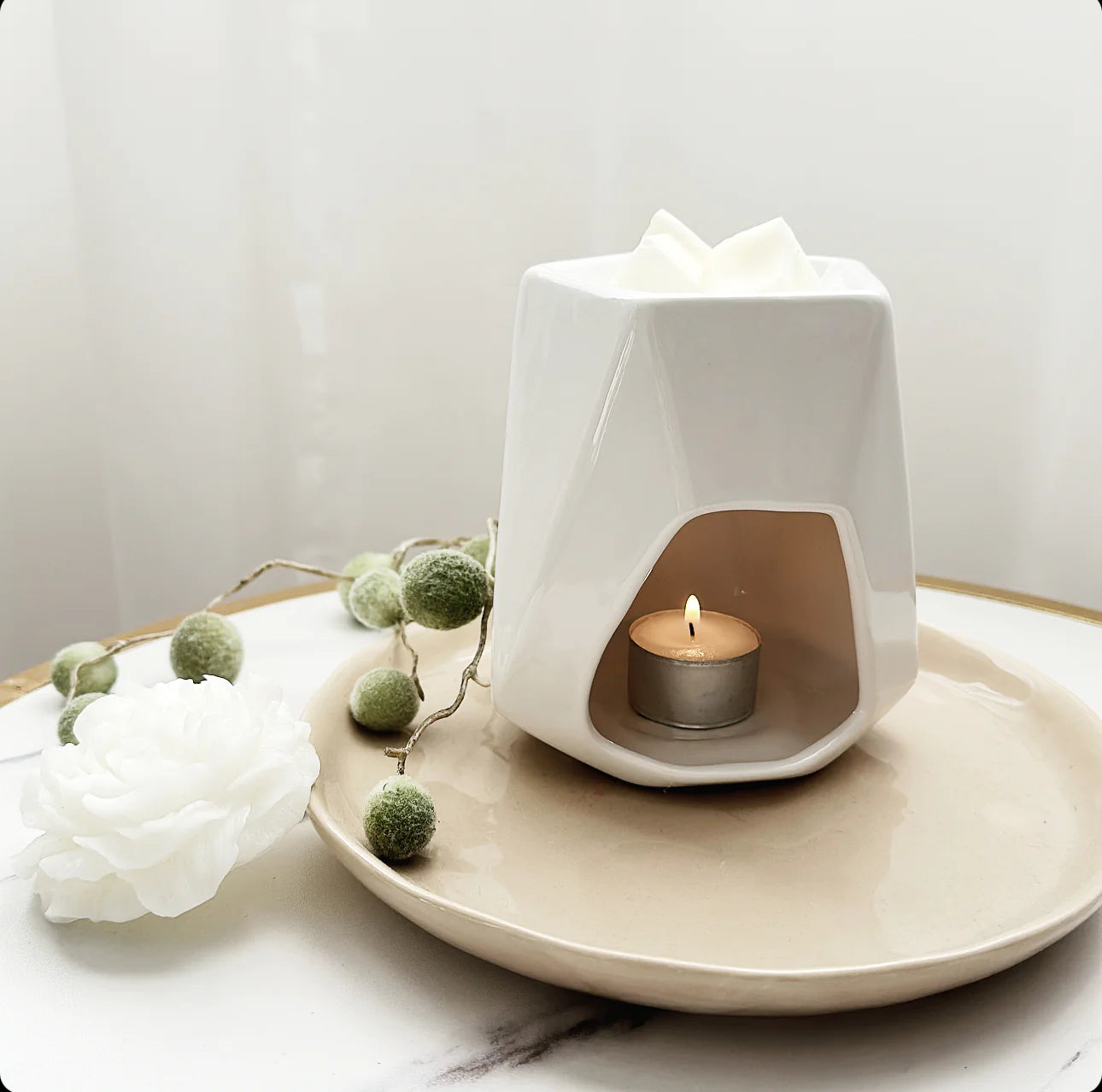 A ceramic wax melt burner for use with tea lights and wax melts.