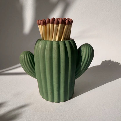 Cactus-shaped matchbox with matches on a light background