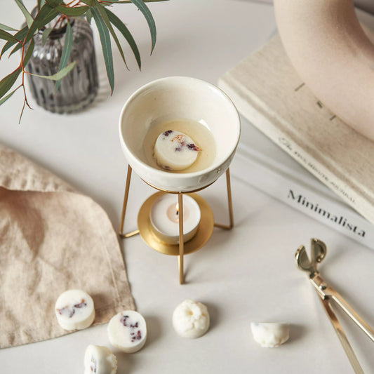 Our Embers Wax Melts slowly melt in a bronze wax warmer, heated by a tea light beneath it.