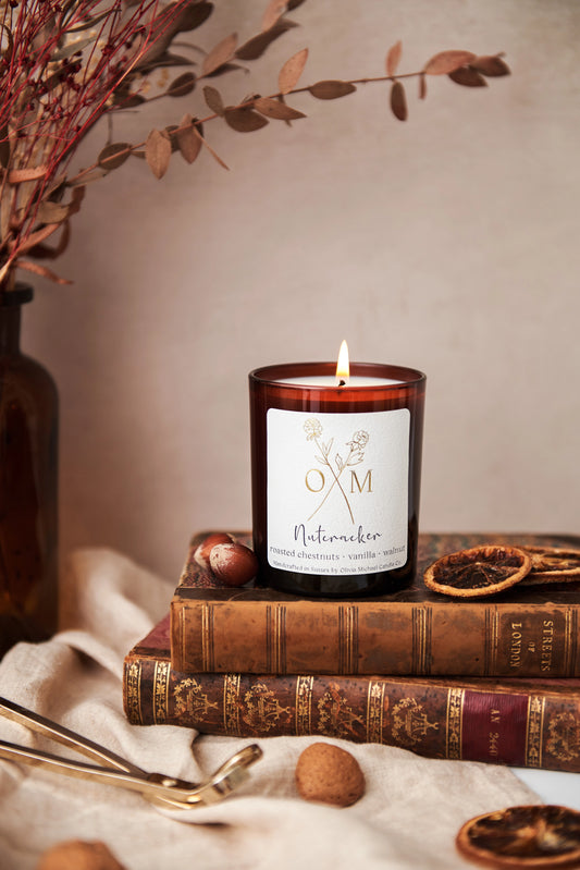 Our roasted chestnuts and vanilla scented candle is on display in an amber glass jar.