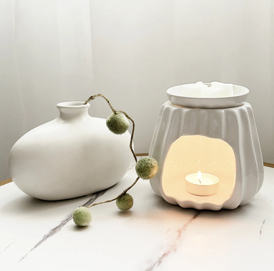 A ceramic wax melt burner for use with tea lights and wax melts.
