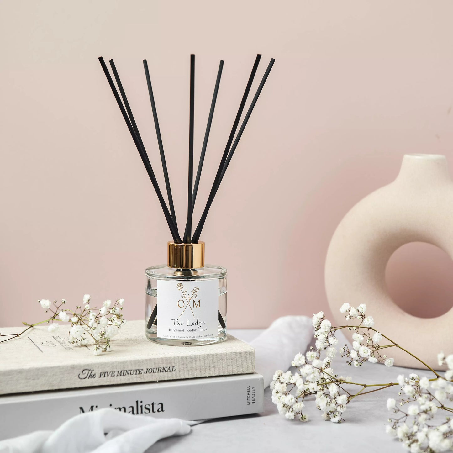 Our bergamot and cedar diffuser is on display in a clear glass jar.
