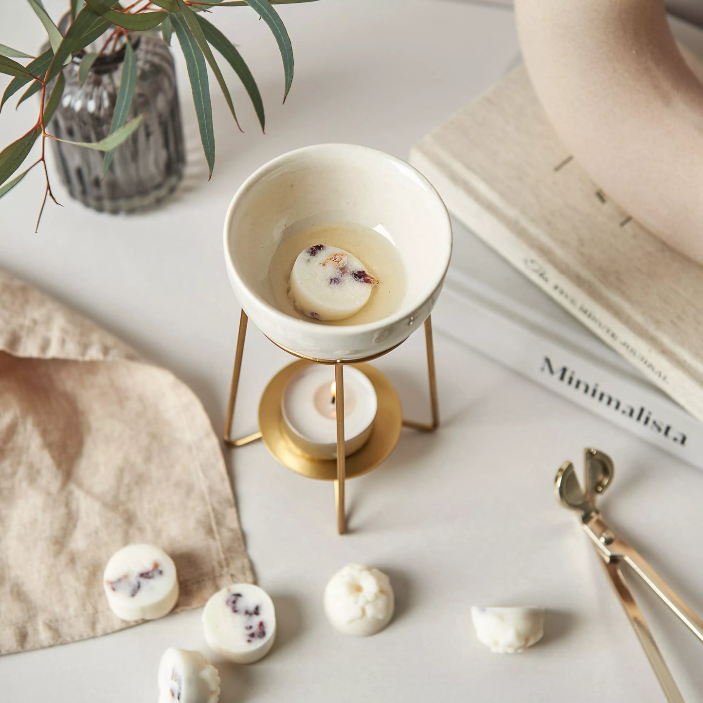 Our Breathe Wax Melts slowly melt in our bronze wax warmer, heated by a tea light beneath it.