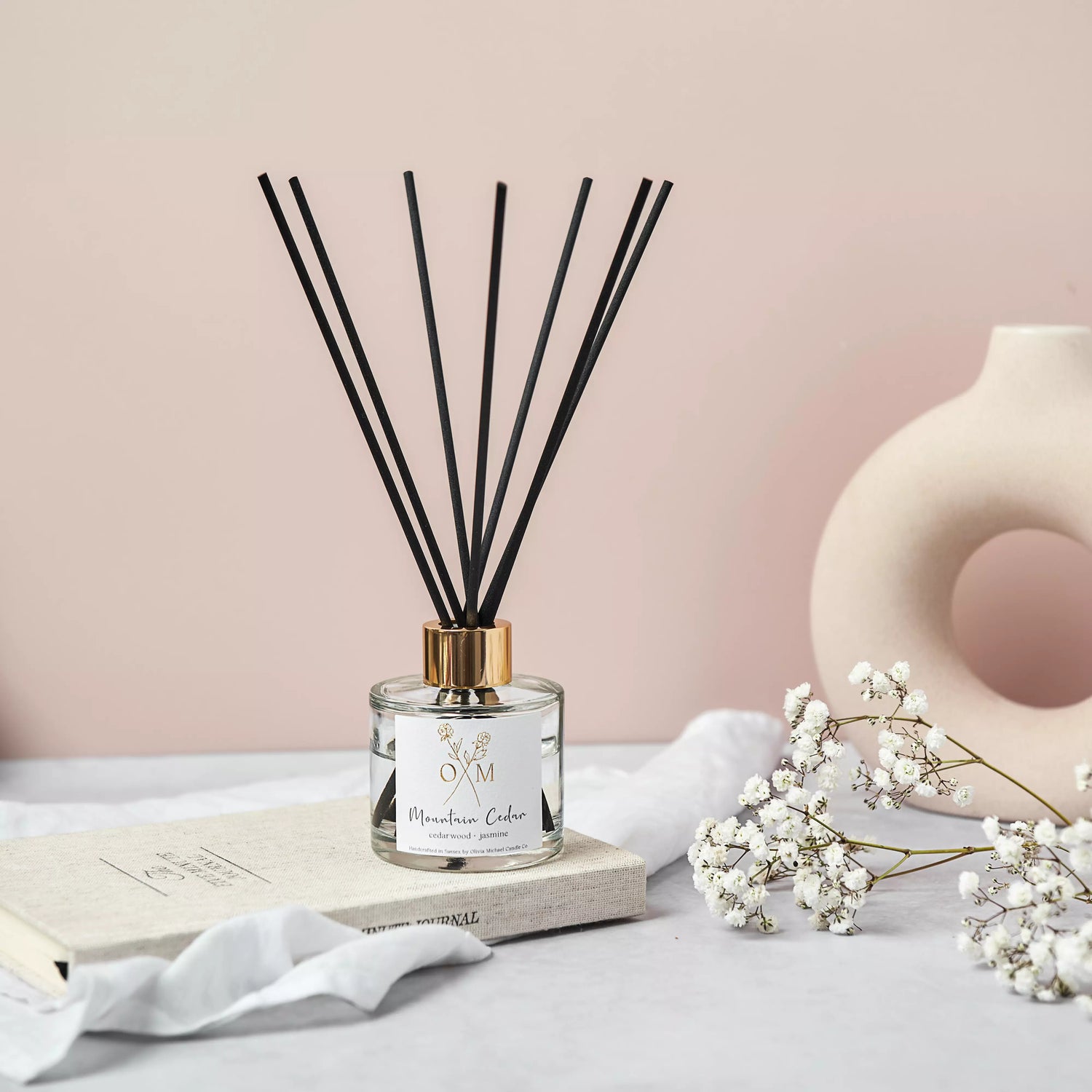 Our cedarwood and jasmine diffuser is on display in a clear glass jar.