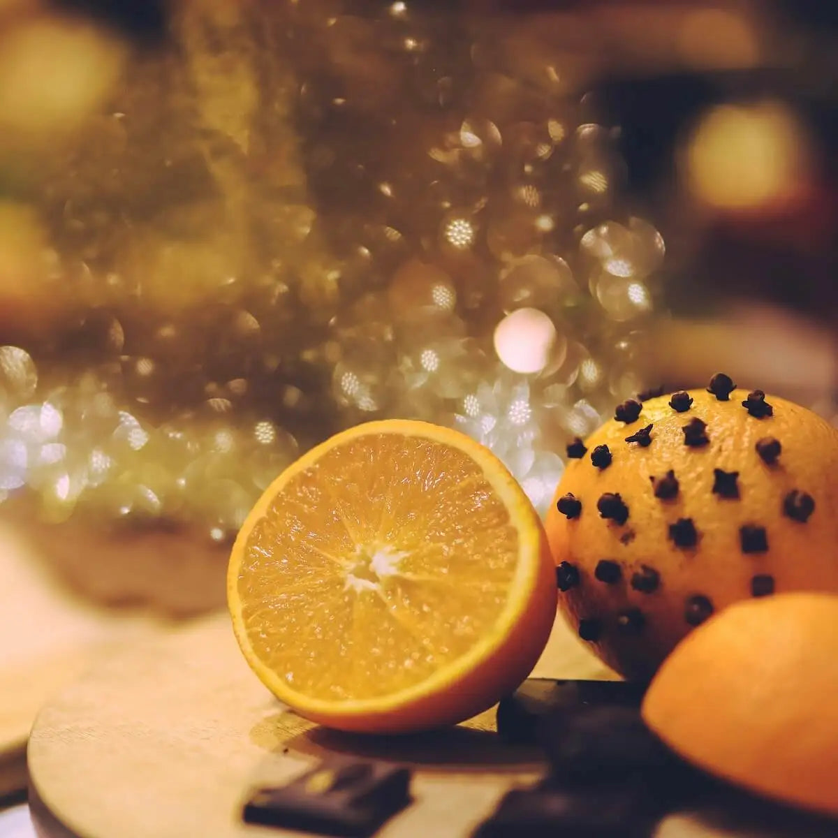 A close up of some spiced oranges with cloves inserted into the skin.