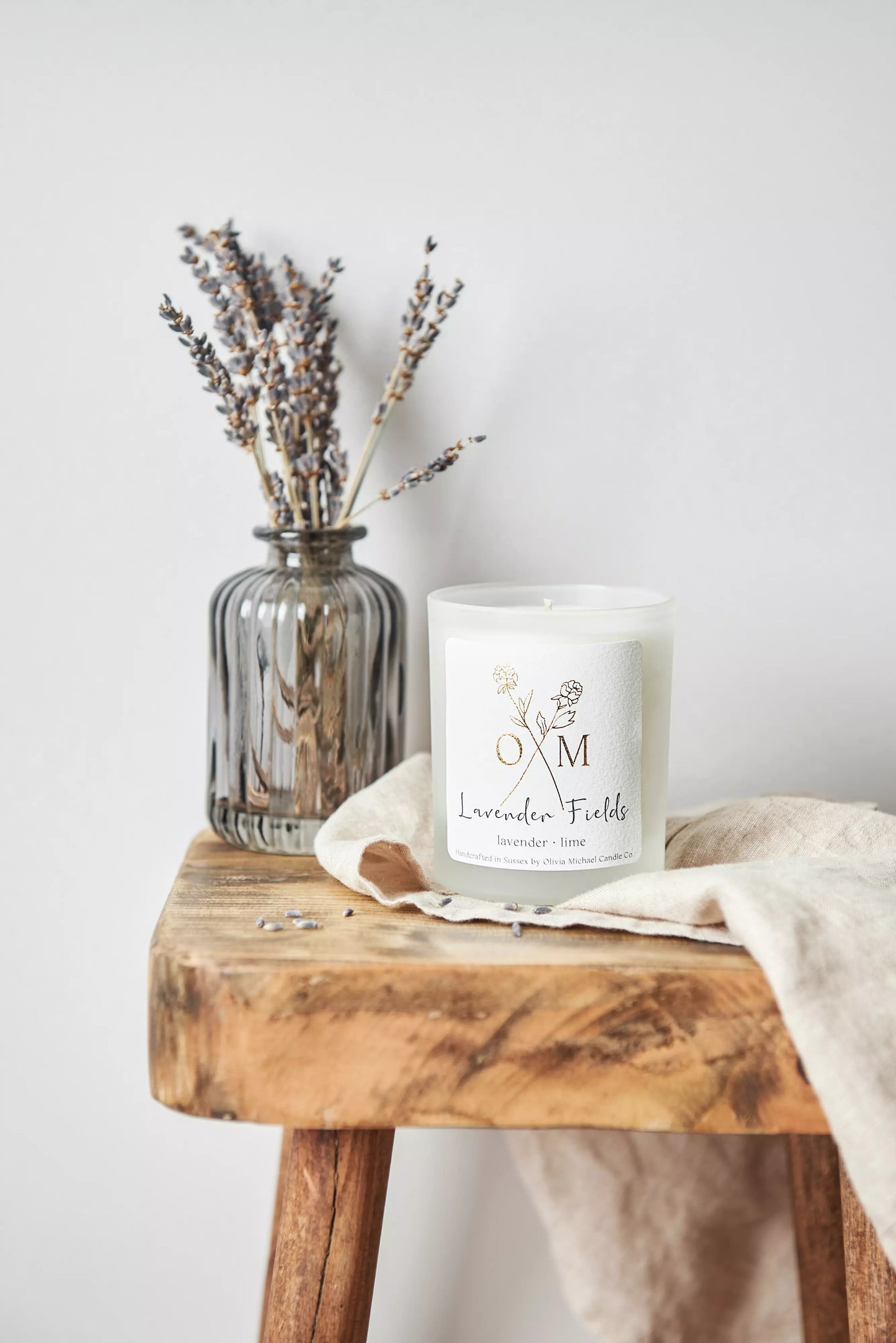 Our lavender aromatherapy candle is on display in a clear frosted glass jar.