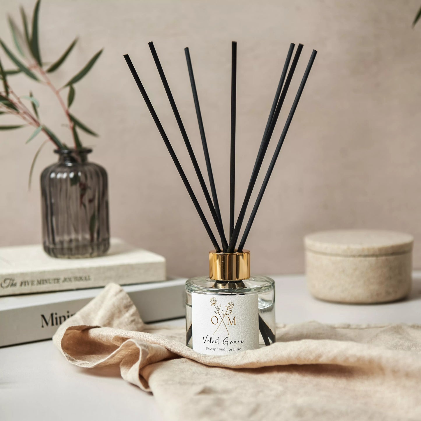 Our peony and oud diffuser is on display in a clear glass jar.